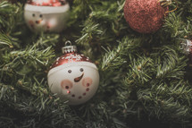 Snowman Christmas ornaments on greenery