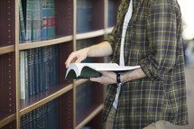 a man checking out a book at a library 