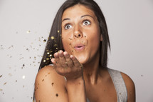woman blowing confetti 