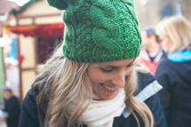 woman in a wool cap looking down 