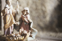 figurines of Mary and Joseph with baby Jesus. 