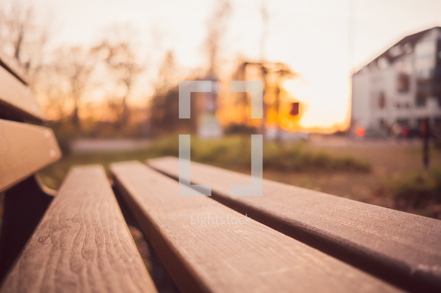 empty park bench at sunset 