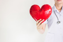 a healthcare worker holding a heart with milk 