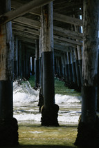 ocean water under a pier 