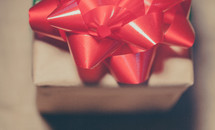a red bow on a wrapped gift 