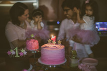 a family celebrating their daughter's first birthday 