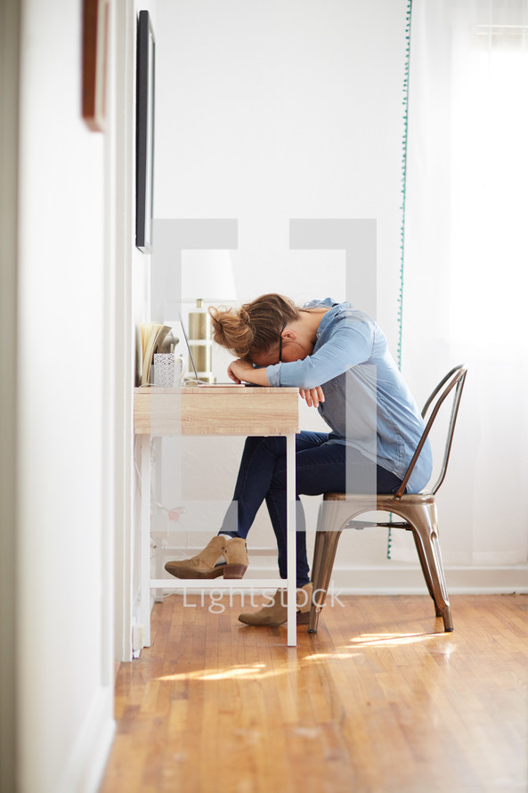 exhausted woman at a desk 