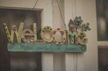 A welcome sign on a window