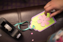 Hand on a decorated gift tag.