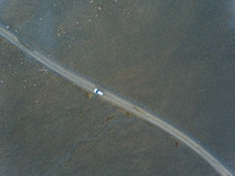 car traveling on a desert road 