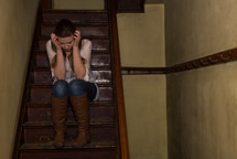 frustrated teen girl sitting on stairs 