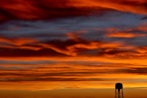 Silhouette of a water tower at sunset.