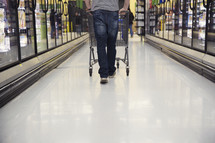 a man pushing a shopping cart through a grocery store
