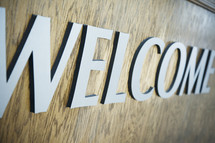 Welcome sign on wood.