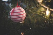 red and white Christmas ornament on a Christmas tree 