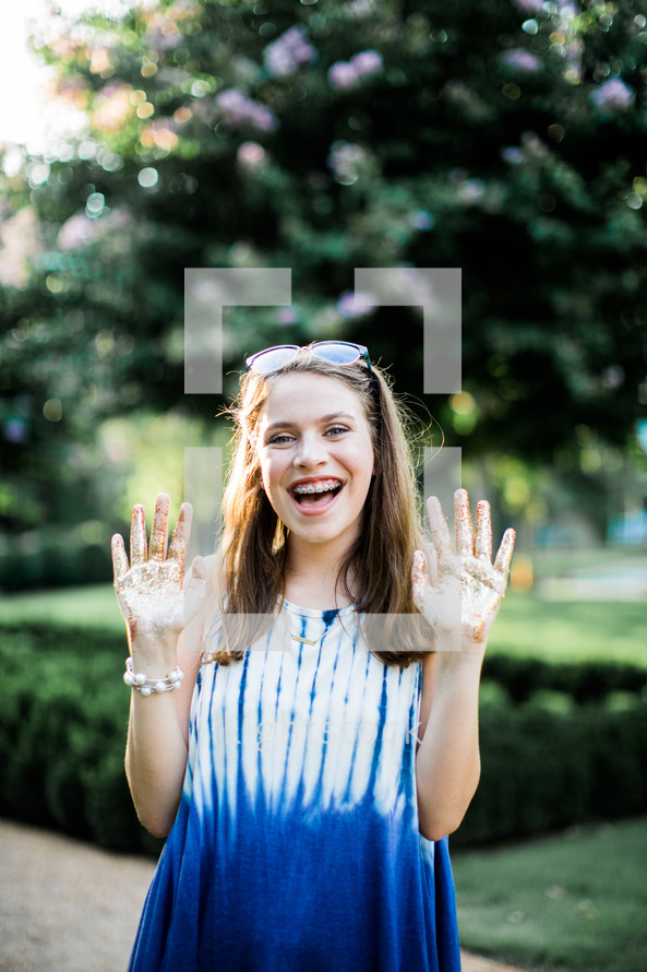 teen girl with glitter on her hands 