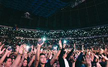 cellphone lights lighting up a concert 