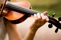 a girl playing a violin 
