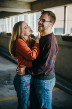 a couple hugging in a parking garage
