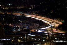 moving cars on a busy highway and city lights at night
