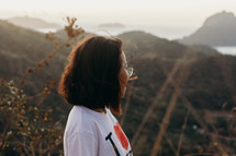 a woman on a mountaintop taking in the view 