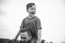 a boy on father's shoulders 