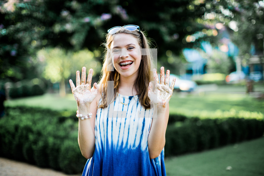 teen girl with glitter on her hands 