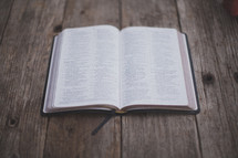 An open Bible on wood