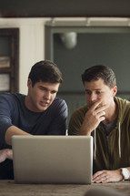 men looking at a computer screen 