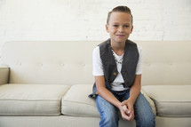 portrait of a boy child sitting on a couch