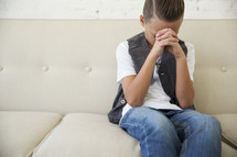 boy child with head bowed in prayer