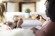 women's group sitting on a couch drinking coffee and reading Bibles 