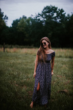 teen girl in a long dress and sunglasses 