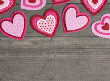 Simple Background with Felt Love Hearts on a Wooden Table