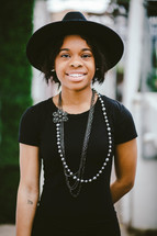 An African American woman in a black hat 