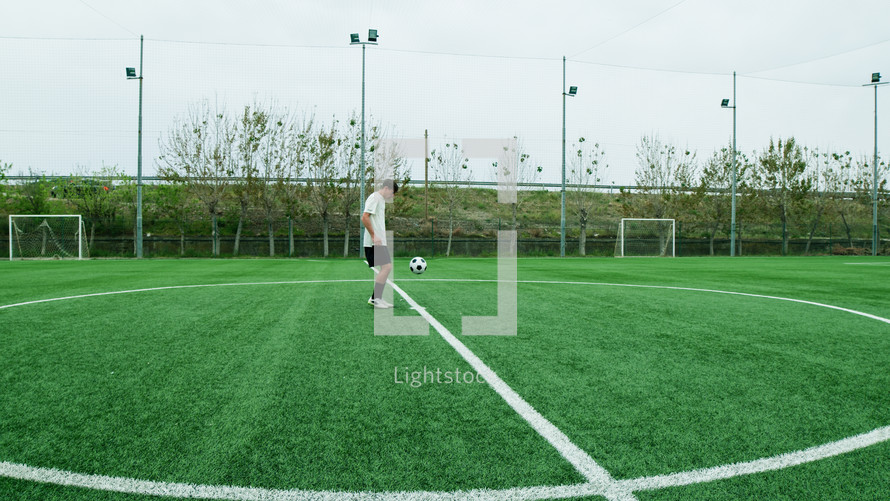 Teenager Does Freestyle Soccer Dribbles In The Field