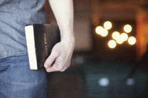 man carrying a Bible to a Bible study 