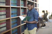 a man checking out books at a library 