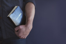 man holding a Bible 