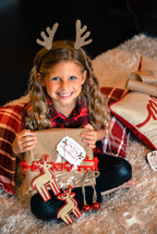 smiling little girl holding a Christmas  present 
