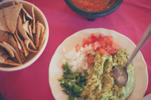bowl of guacamole and chips 
