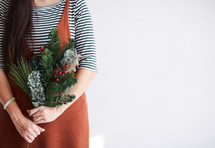 woman holding Christmas greenery 