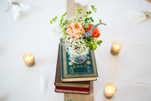 vase of flowers on a stack of books 