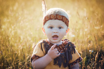 Happy Cute Little Boy dressed in Native American Apache Clothes
