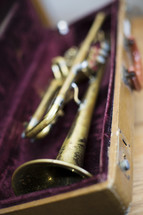 a close up of old trumpet in case