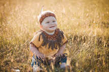 Happy Cute Smiling Little Boy dressed in Native American Apache Clothes
