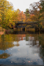 covered bridge over a river in fall 