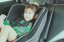 a child in a car seat 