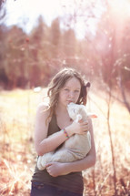 girl child holding a lamb