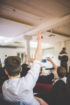 raised hands in a classroom 